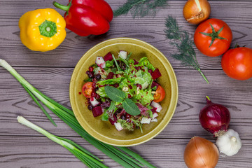 Fresh green salad mix with berries and mint