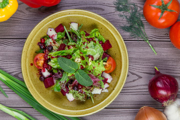 Fresh green salad mix with berries and mint