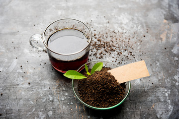 Black Tea Powder or dry dust with or without green leaf and served hot chai in a cup