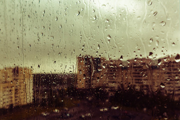 A drop of rain on the window of the sadness of longing, background blur