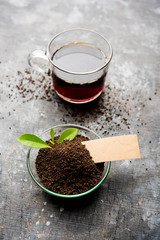 Black Tea Powder or dry dust with or without green leaf and served hot chai in a cup