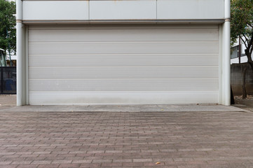 A closeup shot of automatic metal roller door used in factory, storage, garage, and industrial warehouse. The corrugated and foldable metal sheet offer space saving and provide urban and rustic feel