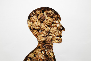 Nuts and human abstraction brain. Healthy food for a person to think. Concept