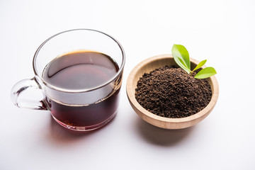 Black Tea Powder or dry dust with or without green leaf and served hot chai in a cup