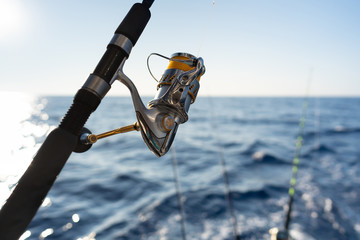 Closeup on fisherman rod on the ocean coast background