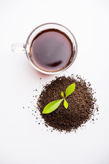 Black Tea Powder or dry dust with or without green leaf and served hot chai in a cup