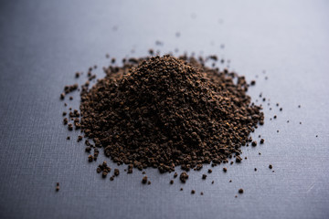 Black Tea Powder or dry dust with or without green leaf and served hot chai in a cup