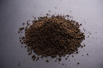 Black Tea Powder or dry dust with or without green leaf and served hot chai in a cup