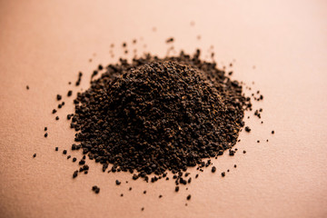 Black Tea Powder or dry dust with or without green leaf and served hot chai in a cup