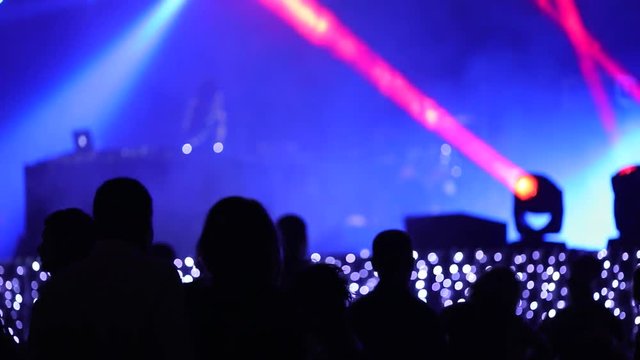 People partying in nightclub. DJ, nightclub light, silhouettes. Slow motion

