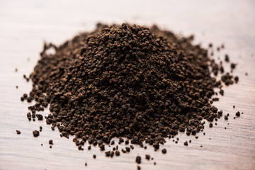 Black Tea Powder or dry dust with or without green leaf and served hot chai in a cup