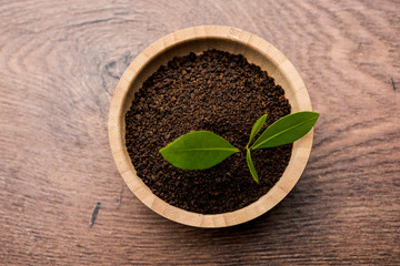 Black Tea Powder or dry dust with or without green leaf and served hot chai in a cup