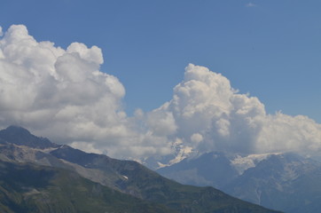 cumulus clouds over a large mountain glacier