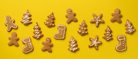 Christmas gingerbread cookies on yellow background. Banner. Top view, copy space. New year concept