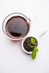 Black Tea Powder or dry dust with or without green leaf and served hot chai in a cup