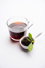 Black Tea Powder or dry dust with or without green leaf and served hot chai in a cup