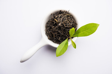 Black Tea Powder or dry dust with or without green leaf and served hot chai in a cup