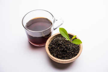 Black Tea Powder or dry dust with or without green leaf and served hot chai in a cup