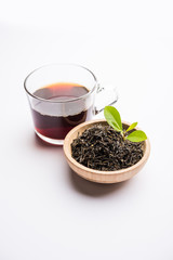 Black Tea Powder or dry dust with or without green leaf and served hot chai in a cup