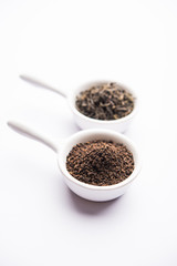 Black Tea Powder or dry dust with or without green leaf and served hot chai in a cup