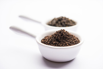 Black Tea Powder or dry dust with or without green leaf and served hot chai in a cup