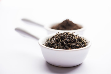 Black Tea Powder or dry dust with or without green leaf and served hot chai in a cup
