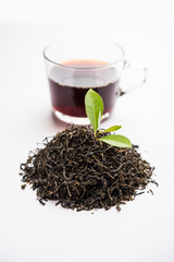 Black Tea Powder or dry dust with or without green leaf and served hot chai in a cup