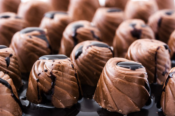 pieces of bonbons covered with melted chocolate  background