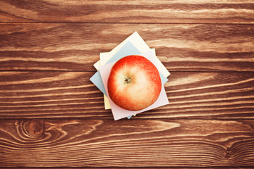 Apple and stickers on wooden background with copy space top view