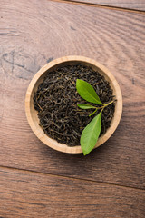 Black Tea Powder or dry dust with or without green leaf and served hot chai in a cup