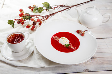 Strawberry soup with ice cream and mint.