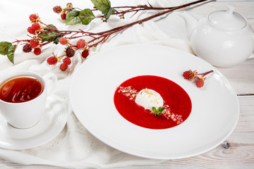 Strawberry soup with ice cream and mint.