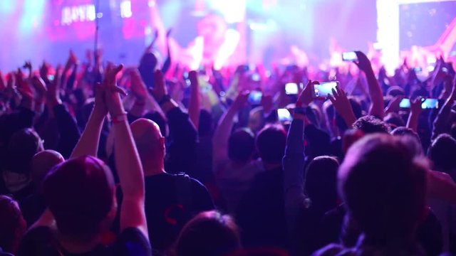 People applaud at live music concert. Slow motion, steadicam shot