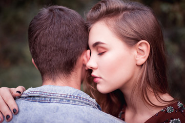 Young girl 16-18 year old with closed eyes holding boy from back close up. Love concept. Valentines...
