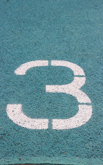 Fototapeta premium digit 3 on a blue athltetics track