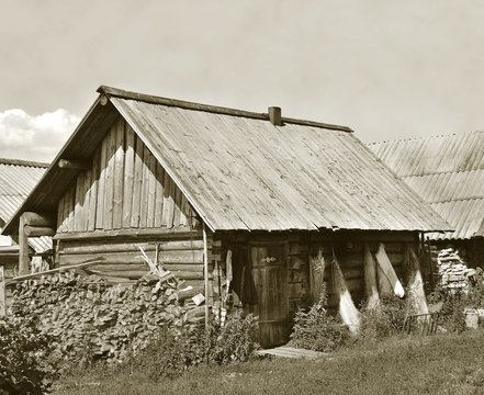 Old wooden shack with stack of firewood