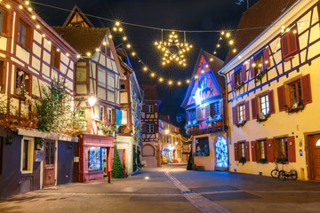 Fototapeta na wymiar Traditional Alsatian half-timbered houses in old town of Colmar, decorated and illuminated at christmas time, Alsace, France