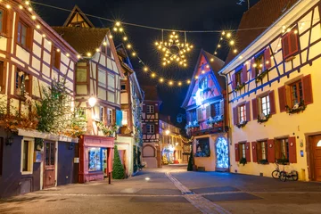 Foto op Canvas Traditional Alsatian half-timbered houses in old town of Colmar, decorated and illuminated at christmas time, Alsace, France © Kavalenkava
