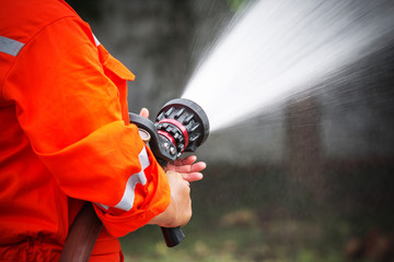Firefighters are using a fire extinguisher to fire.