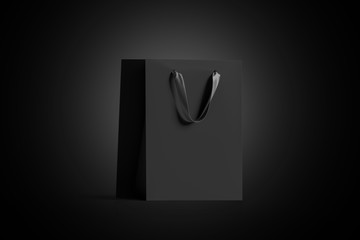 Blank black paper gift bag with silk handle mock up, isolated in darkness, 3d rendering. Empty craft shopping packet mock up, side view. Carry bagful for print design.