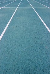 Fototapeta premium running racetrack with white lines on blue ground
