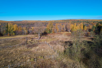 Fototapeta premium High-altitude shooting of the autumn glade with a wooden fence
