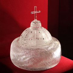 Glass crown on red background