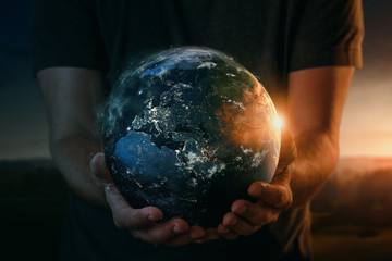 Planet earth in human hands. Elements of this image furnished by NASA