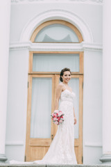 Fototapeta premium Beautiful bride at the castle on the street. Shooting on Elagin island. Russian wedding in St. Petersburg.