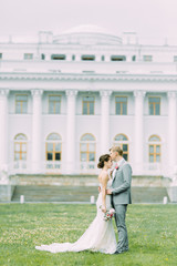 Stylish wedding in St. Petersburg. Elagin island and castle in the background. Walking photo session of the couple.