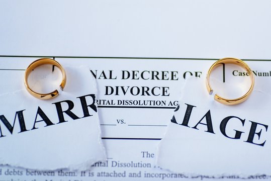 Divorce decree and two broken wedding rings
