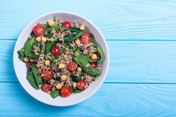 Spinach salad with quinoa , tomatoes and chickpea