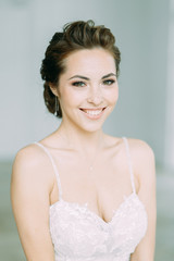 Beautiful bride in a white Studio. Russian wedding in St. Petersburg. Portrait and details in fine art style.