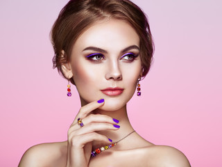 Portrait Beautiful Woman with Jewelry. Model Girl with Violet Manicure on Nails. Elegant Hairstyle. Violet Make-up Arrows. Beauty and Accessories
